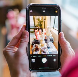 Holding up a mobile phone to take a photo
